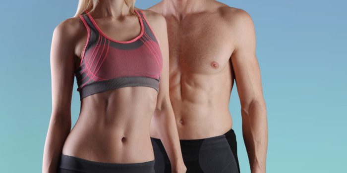Fit couple, strong muscular man and slim woman . Sport, fitness ,workout concept. Copy space